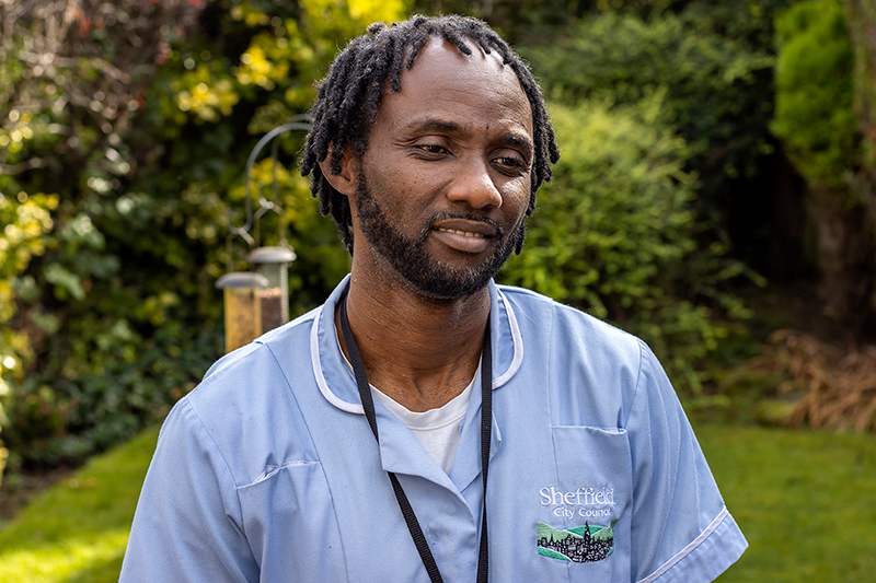 Carer stood in a garden