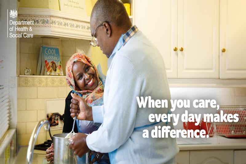 Two carers in a kitchen cooking with the text "when you care, every day makes a difference" and the department of health & social care logo in the top left hand corner