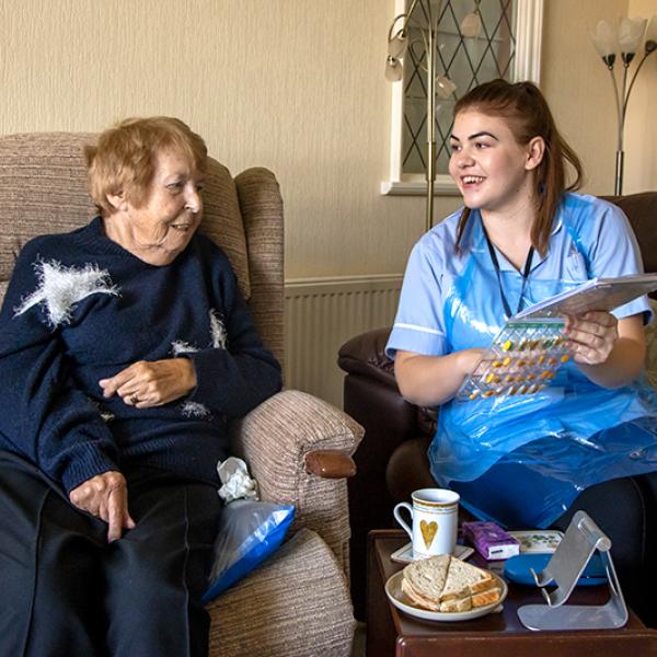 Carer and client sat in a living room