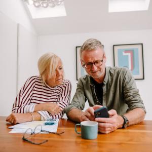Two people looking at a phone